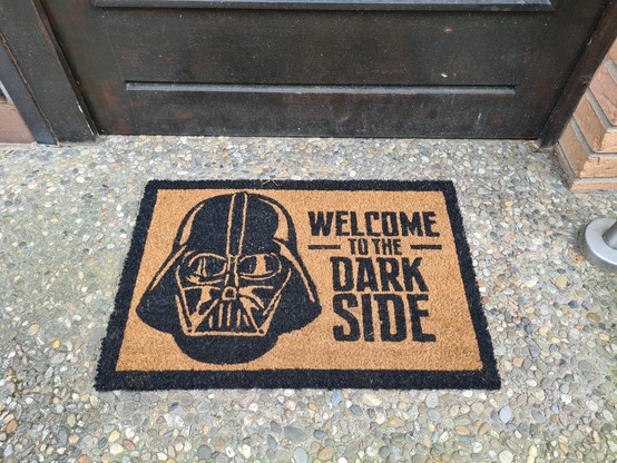 Doormat with Darth Vader helmet and text: 
welcome to the dark side